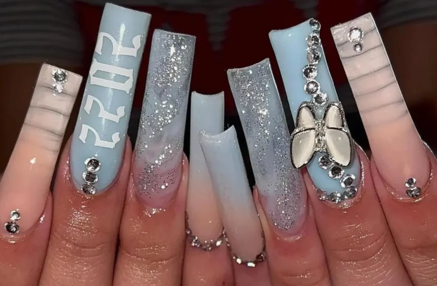 set of long square light blue nails with sparkles, a butterfly, and the number 2022