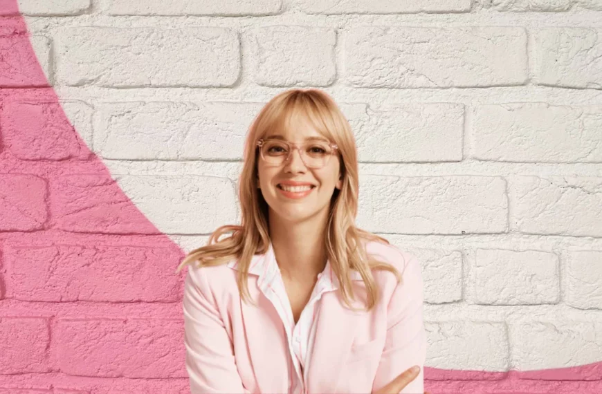 woman with blonde hair smiling, wearing clear glasses from pair eyewear