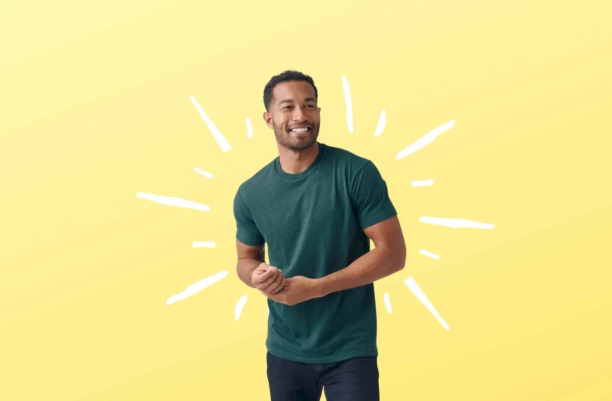 man smiling, looking off camera, wearing a green True Classic tshirt