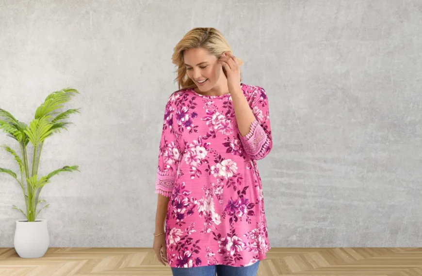 woman looking down, smiling, wearing pink floral shirt from Woman Within