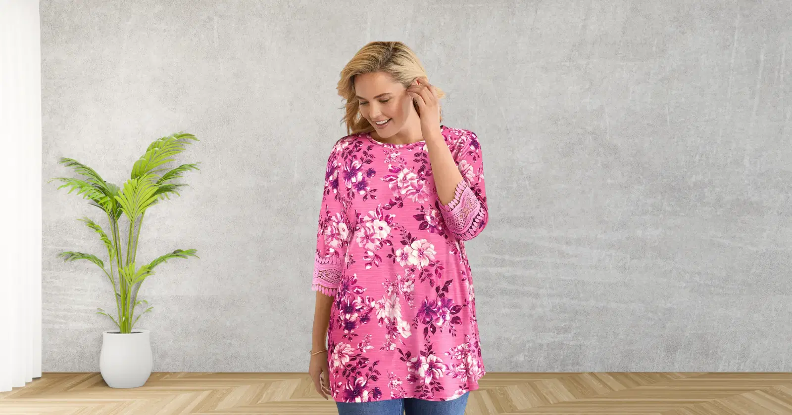 woman looking down, smiling, wearing pink floral shirt from Woman Within