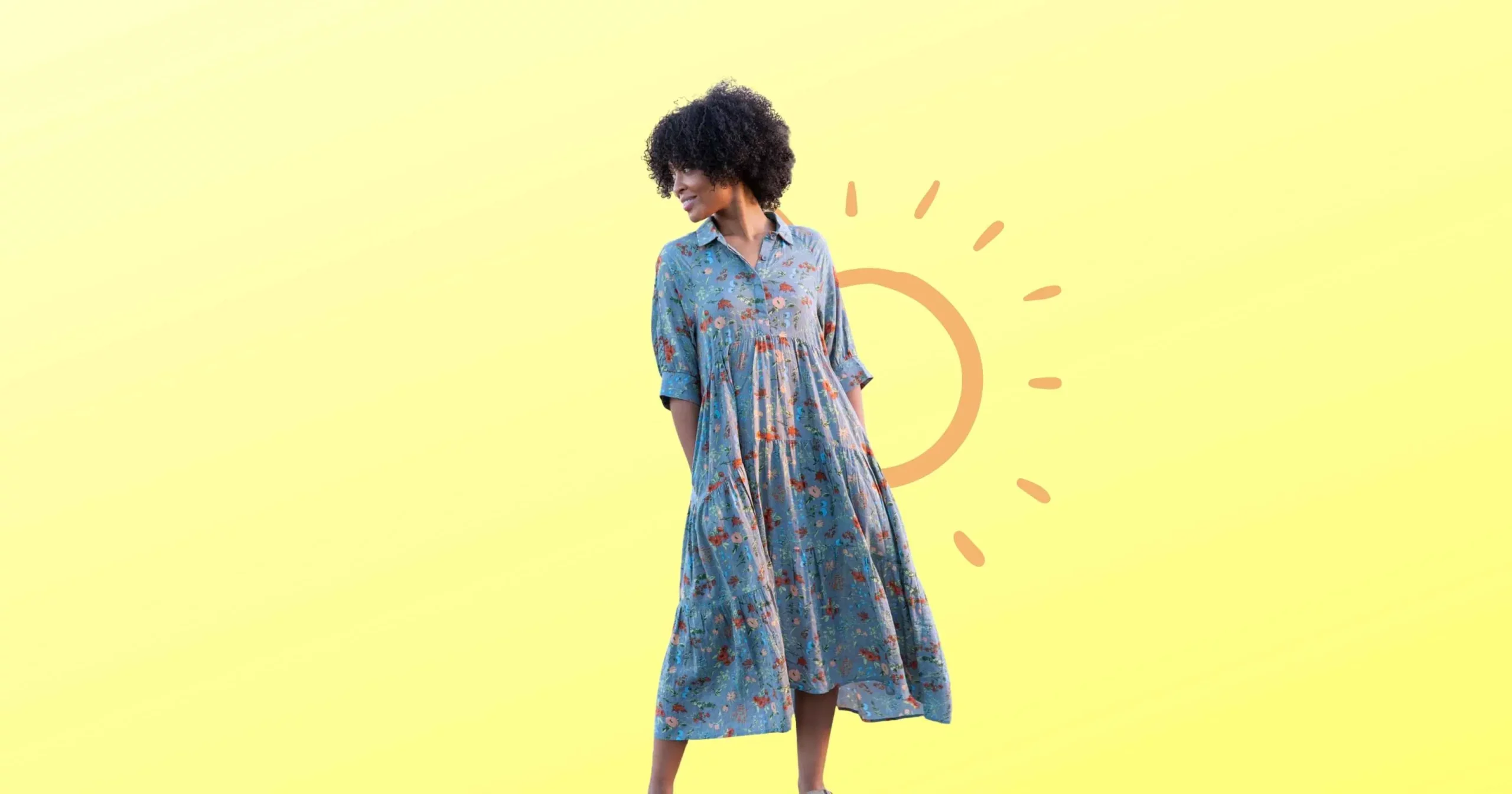 woman looking over shoulder wearing blue floral dress from Natural Life Clothing