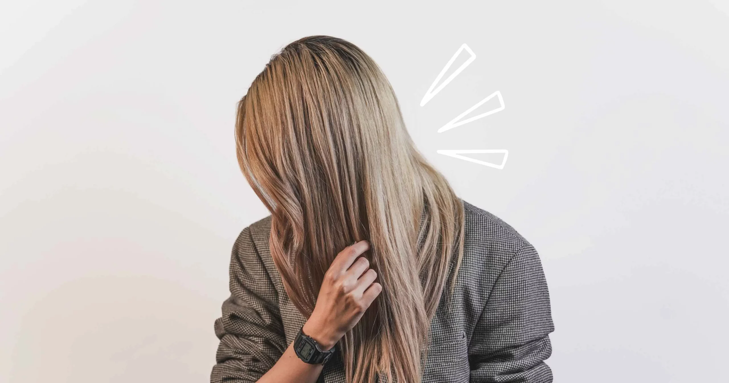 side view of woman with long blonde straight hair, touching it with her hand