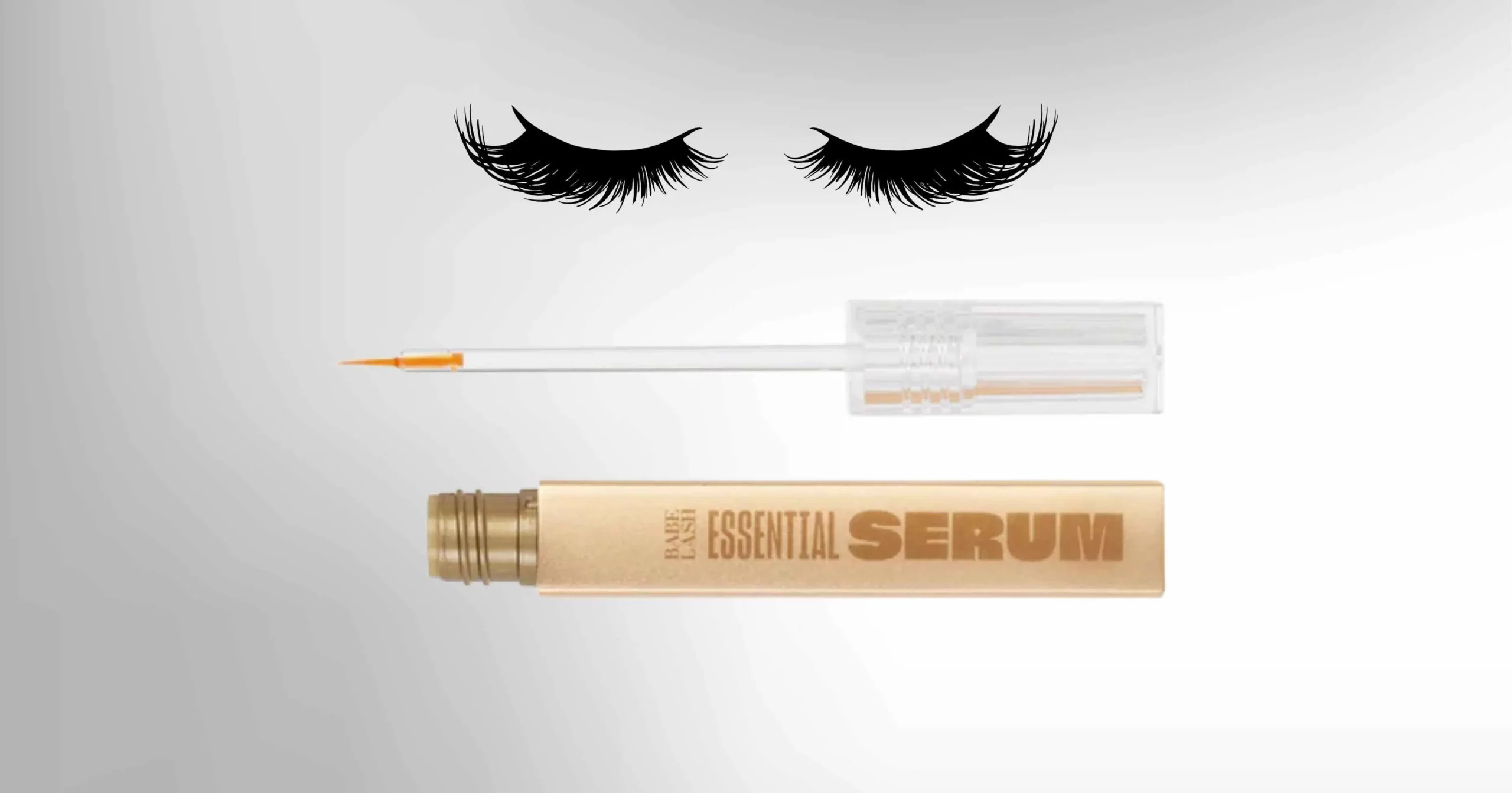 set of eyelashes on top, underneath is a gold bottle of Babe Lash Essential Serum