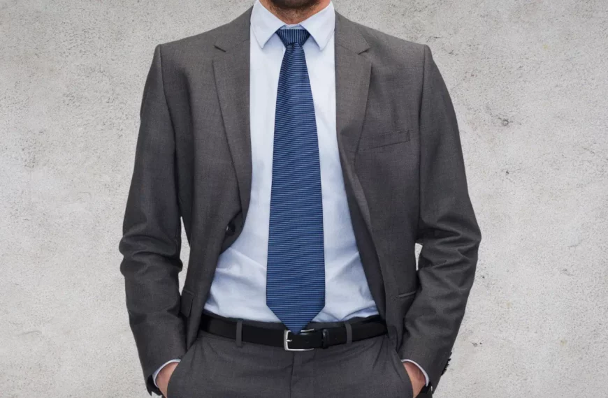 person wearing gray suit and blue tie