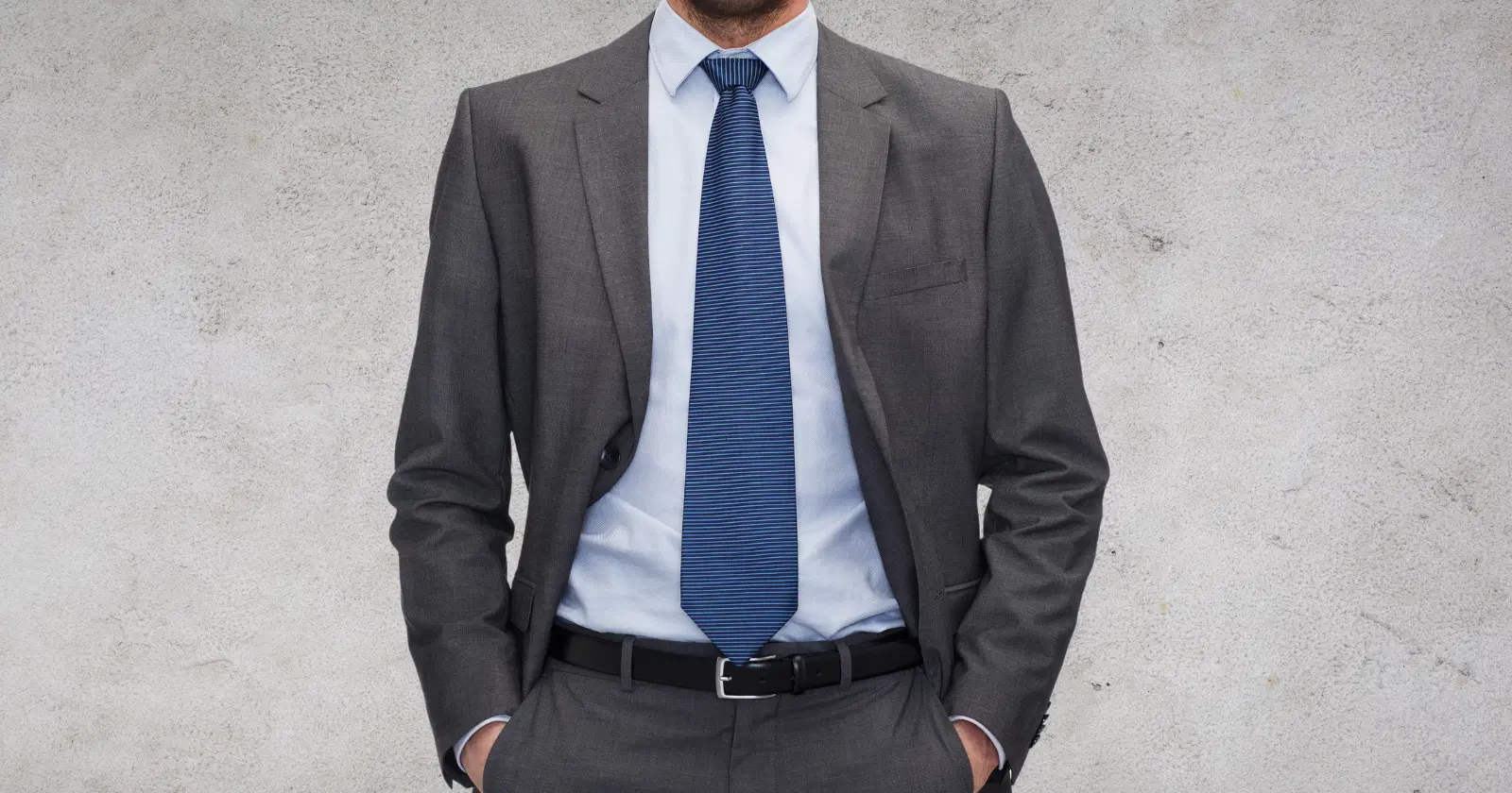 person wearing gray suit and blue tie