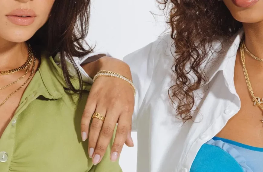 closeup of two women wearing jewelry from The GLD Shop including necklaces, bracelets, and rings