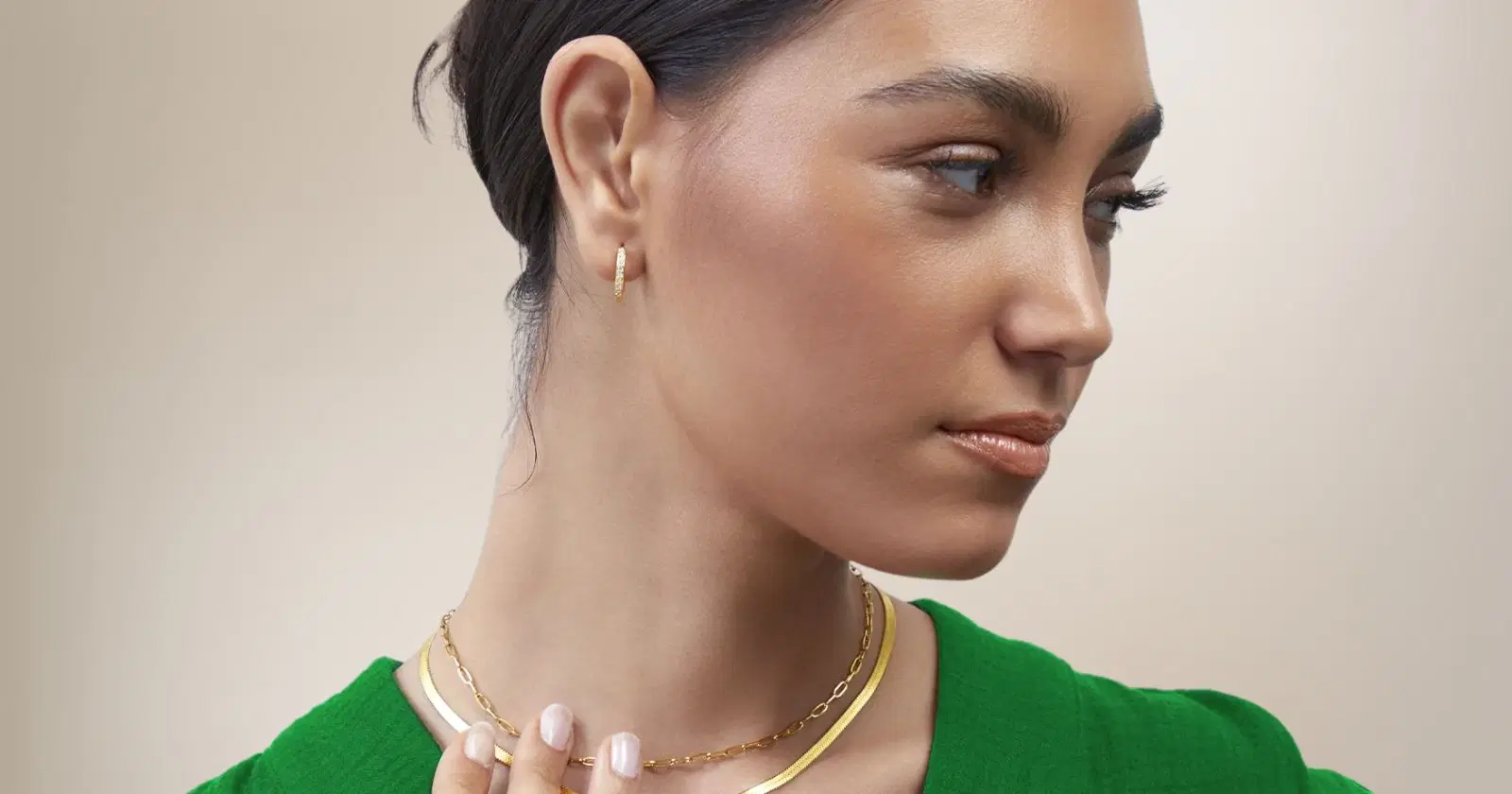 close-up of woman wearing necklaces and earrings from Mint and Lily