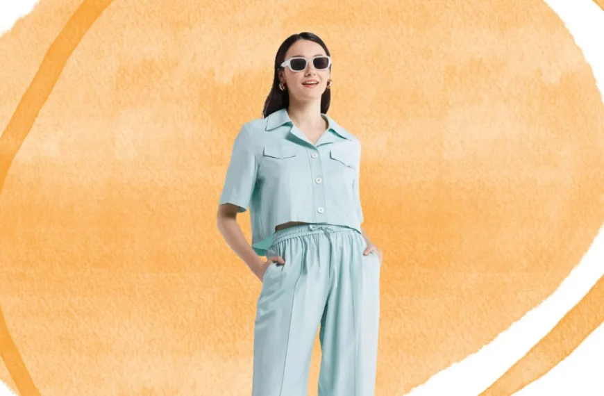 woman looking off camera, hand in her pockets, wearing sunglasses and blue outfit from Lattelier