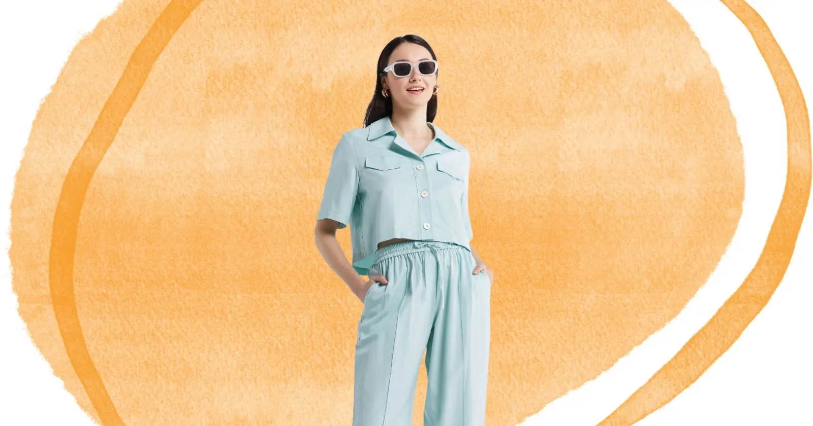 woman looking off camera, hand in her pockets, wearing sunglasses and blue outfit from Lattelier