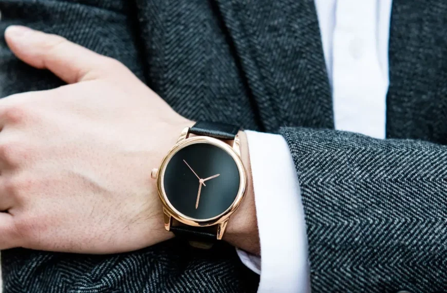 closeup of person's arm and hand wearing a black watch on wrist