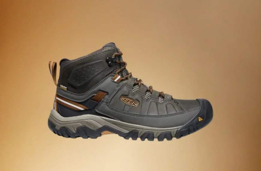 black Keen hiking boot on brown background