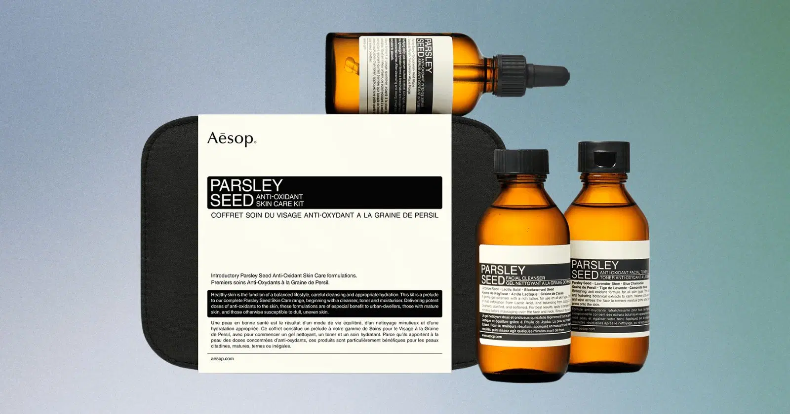 assortment of Aesop skincare products in orange bottles and black box