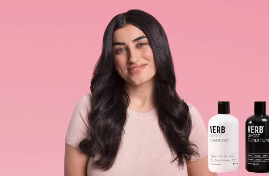 woman with long brown hair smiling at camera, bottles of Verb Ghost shampoo and conditioner in corner