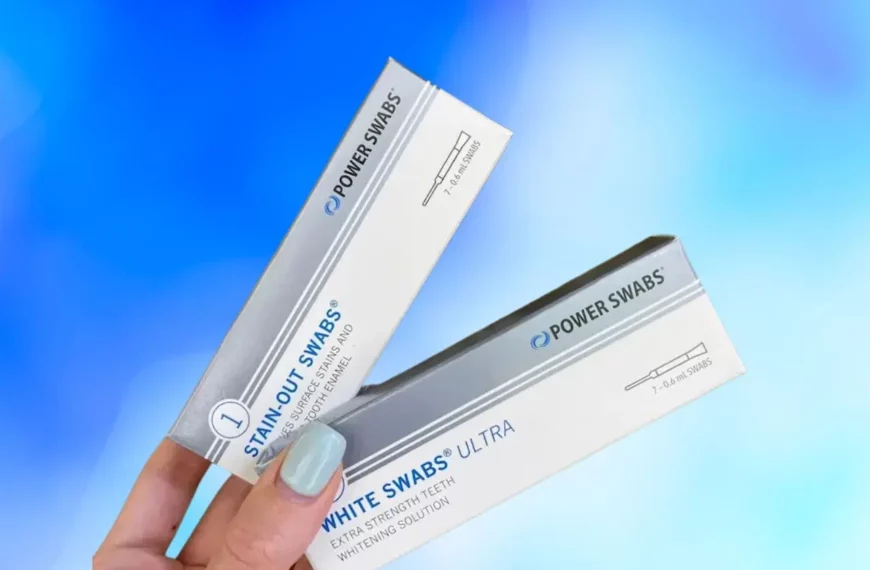 person's hand holding up two Power Swabs whitening solution boxes