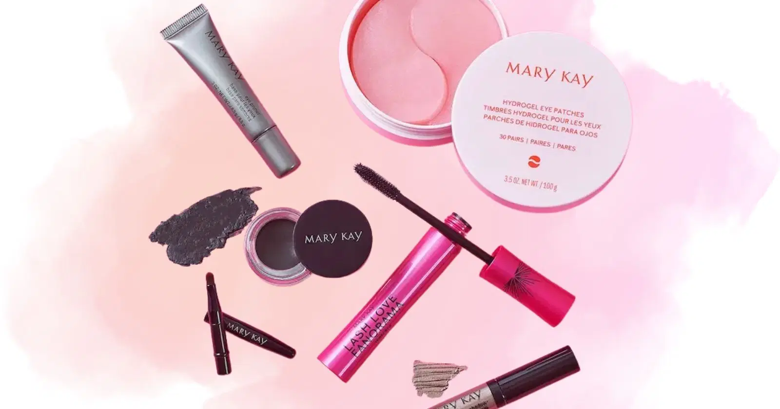 assortment of Mary Kay beauty products against white and pink background