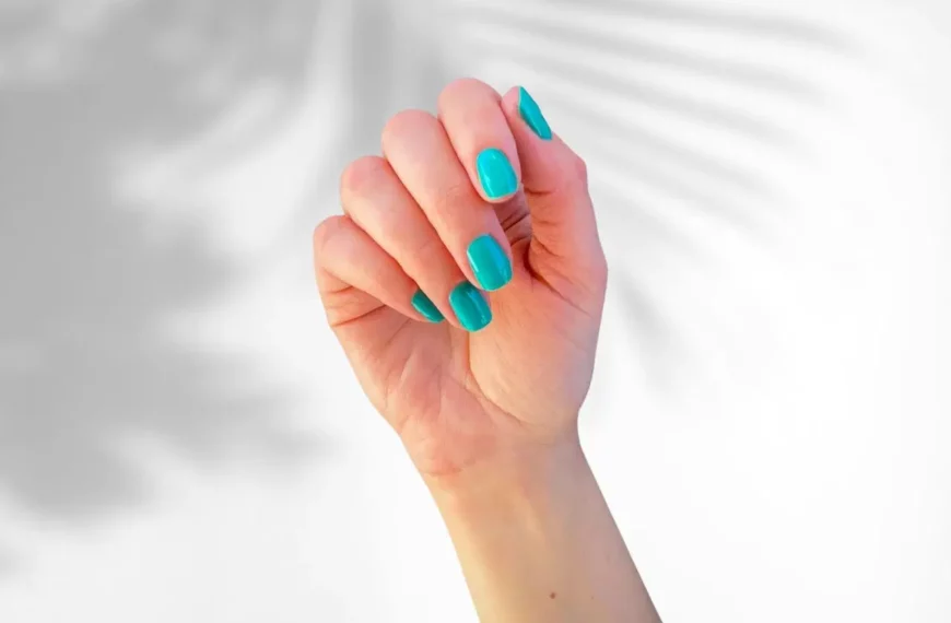 close up of person's hand with teal nail polish from Dazzle Dry